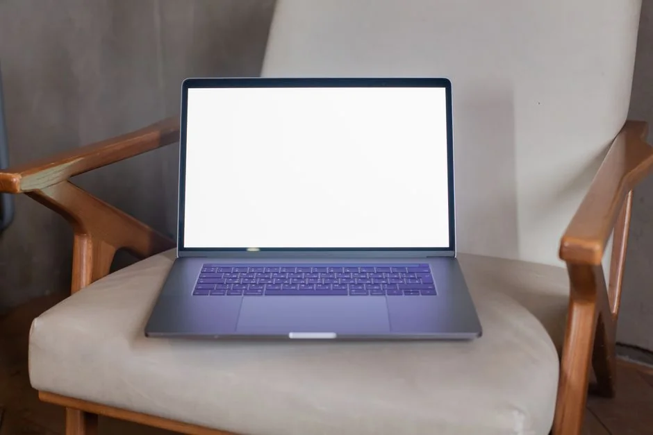 A sleek office desk setup featuring Apple devices: iMac, MacBook, and iPad.
